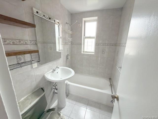 59-30 108th Street, Unit 6J Queens, NY 11368 - Photo 12 of 22 Full bath featuring bathtub / shower combination, light tile patterned floors, and tile walls