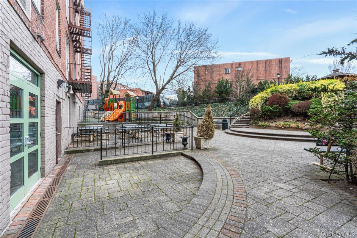 59-30 108th Street, Unit 6J Queens, NY 11368 - Photo 4 of 22 View of property's community featuring a patio area and stairway