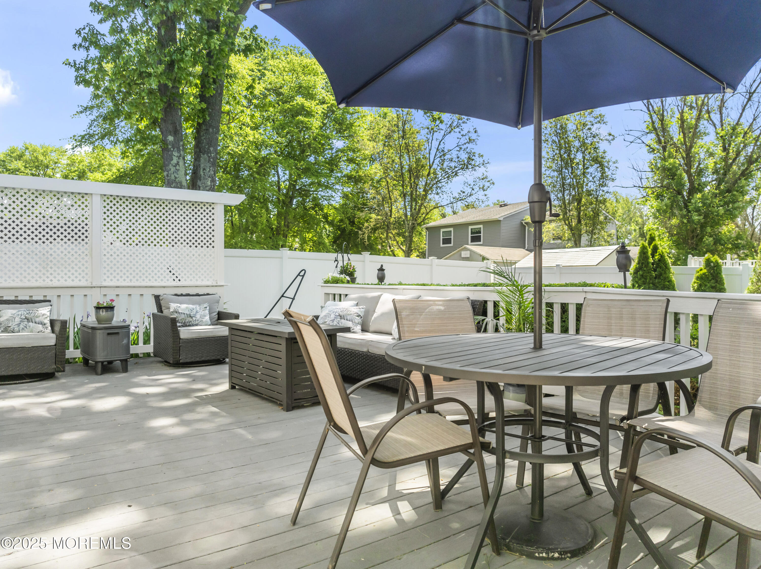 5 Blueberry Path Howell, NJ 07731 - Photo 20 of 25 a view of a patio with table and chairs under an umbrella