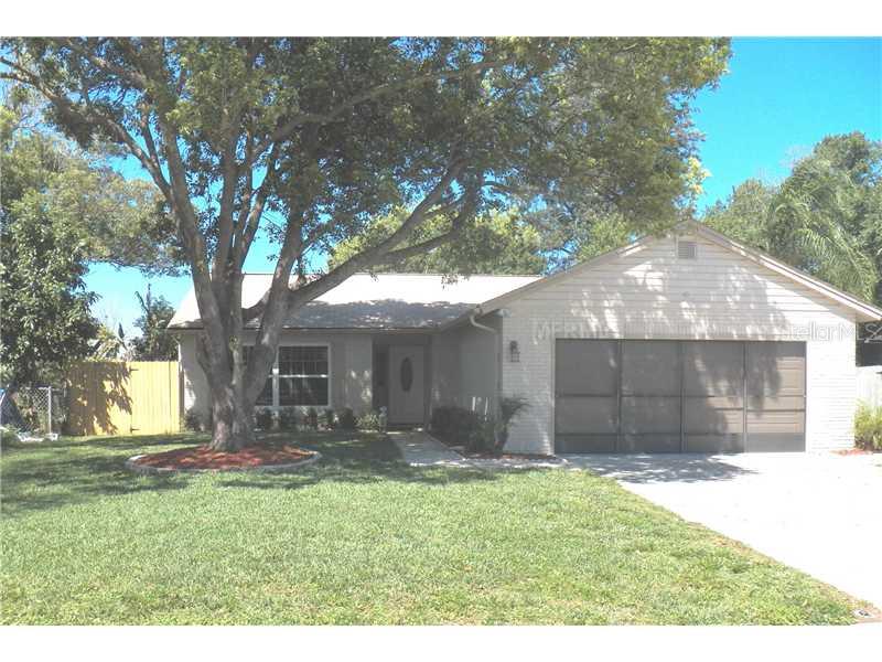 7601 Mitchell Ranch Road New Port Richey, FL 34655 - Photo 1 of 1 a backyard of a house with table and chairs