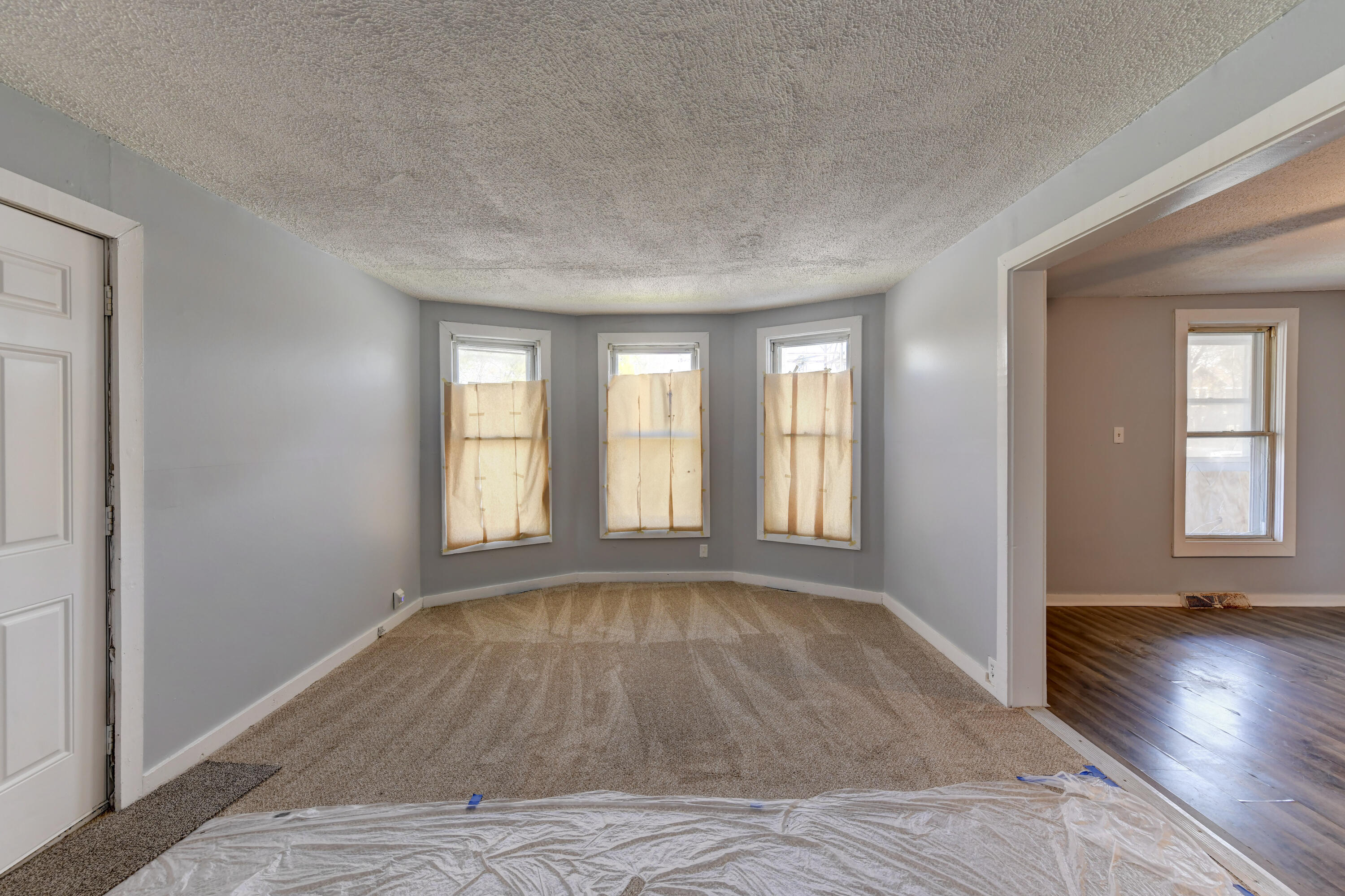 902 Kentucky Street Michigan City, IN 46360 - Photo 17 of 33 wooden floor in an empty room with a window