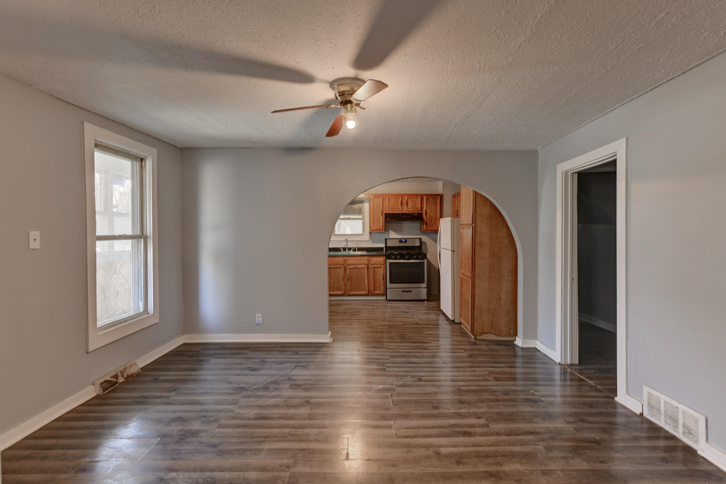 902 Kentucky Street Michigan City, IN 46360 - Photo 21 of 33 wooden floor in an empty room with a window