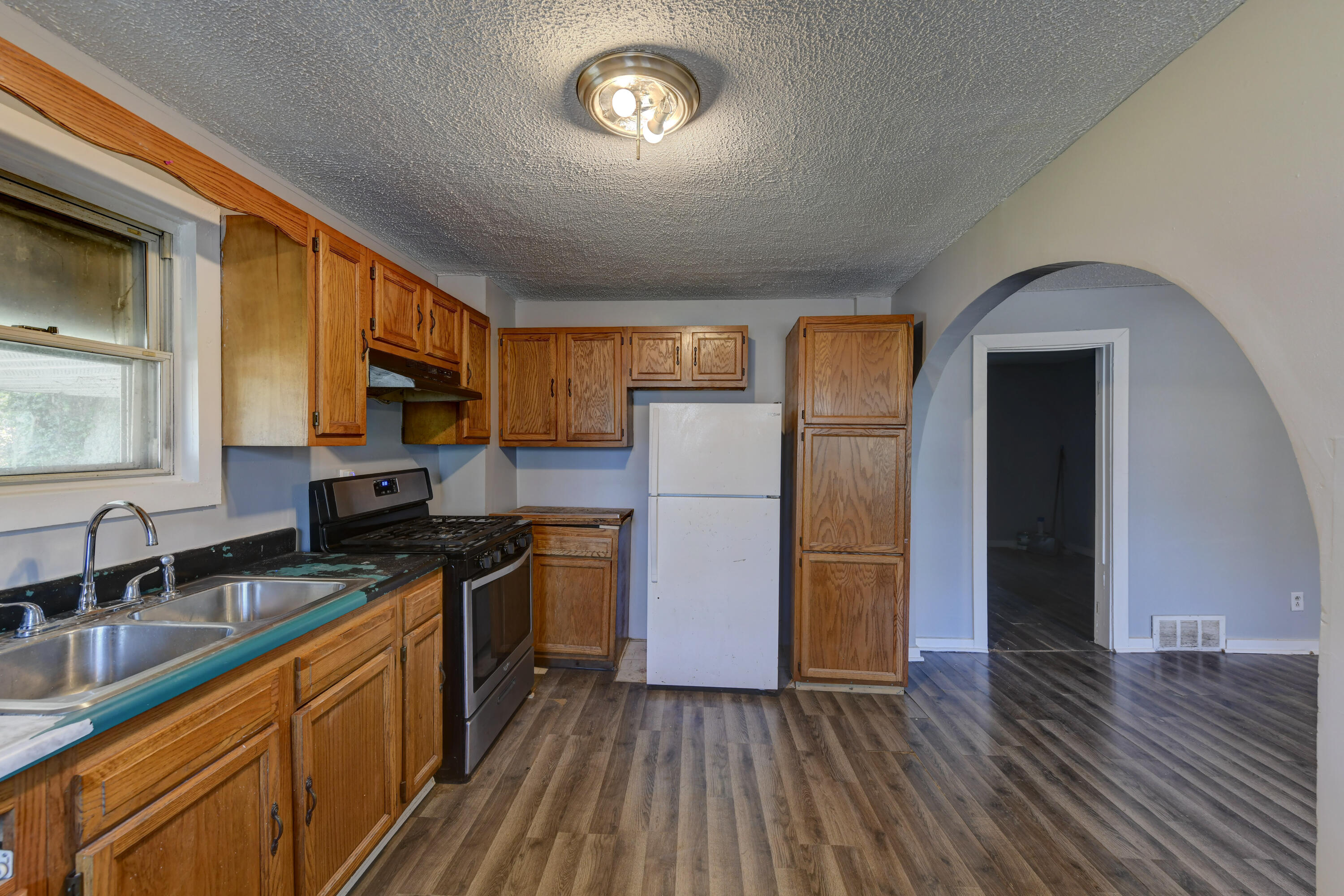 902 Kentucky Street Michigan City, IN 46360 - Photo 25 of 33 a kitchen with stainless steel appliances granite countertop a sink stove and refrigerator