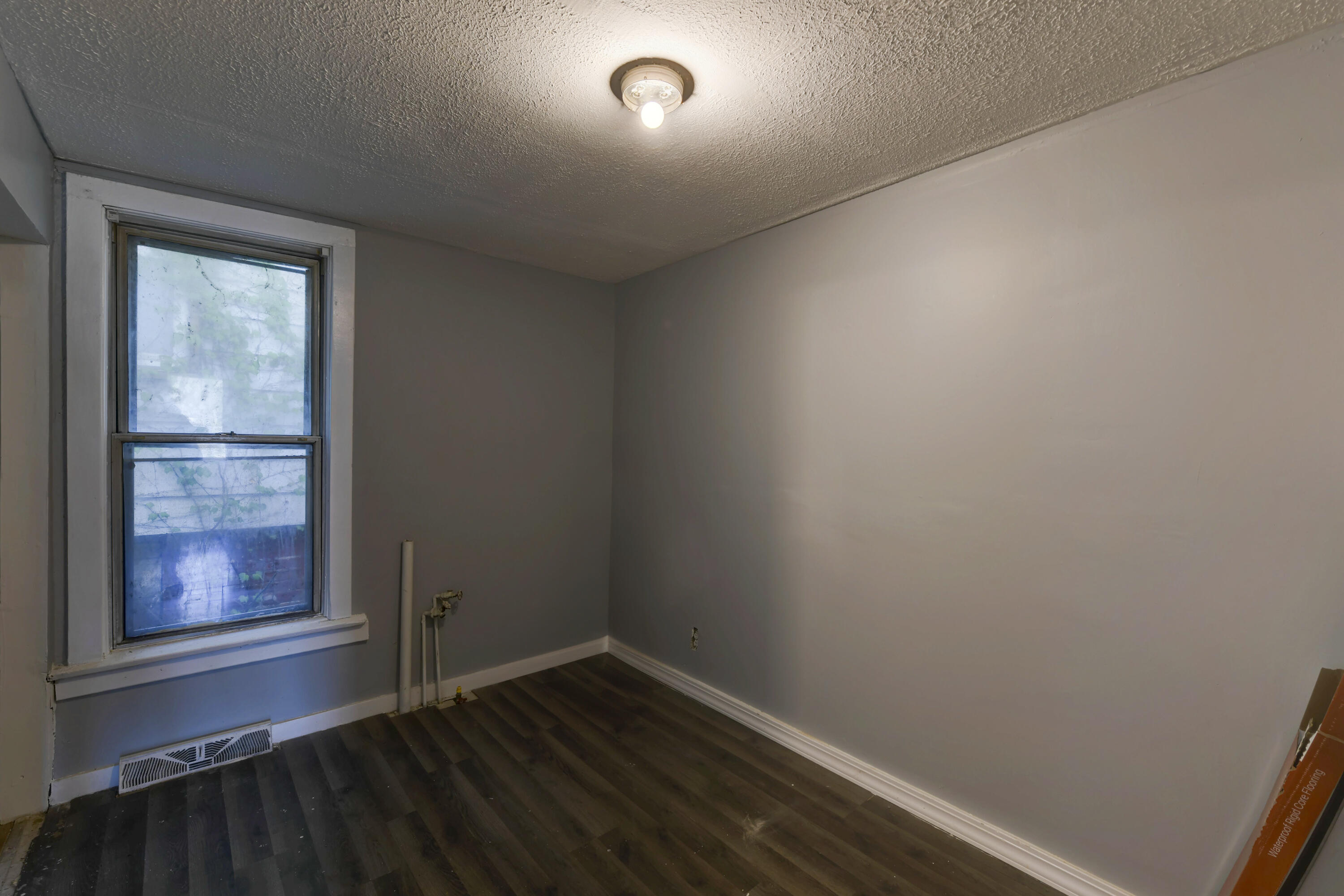 902 Kentucky Street Michigan City, IN 46360 - Photo 27 of 33 an empty room with wooden floor and windows