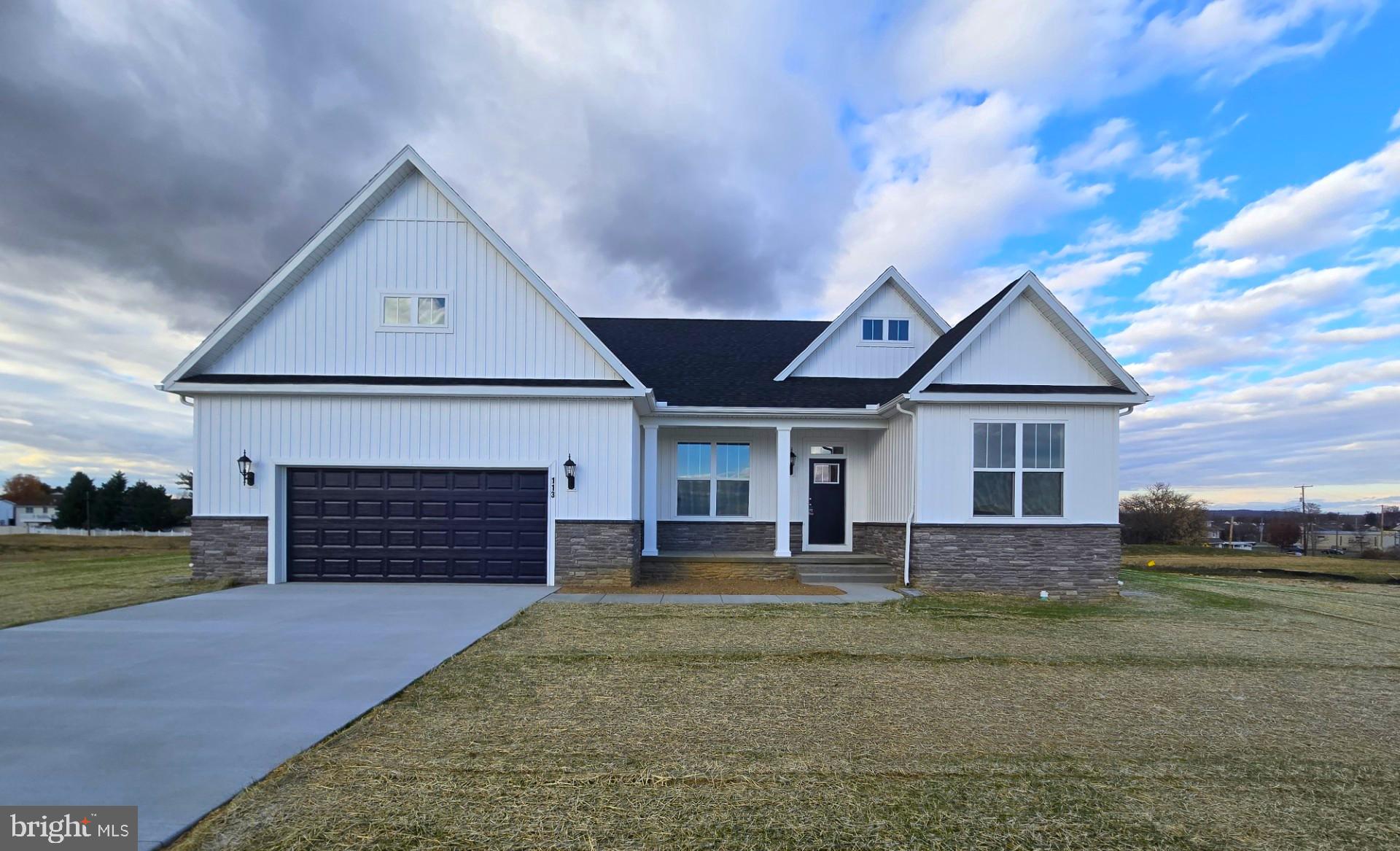 113 Flint Drive Hanover, PA 17331 - Photo 1 of 20 a front view of a house with a yard and garage