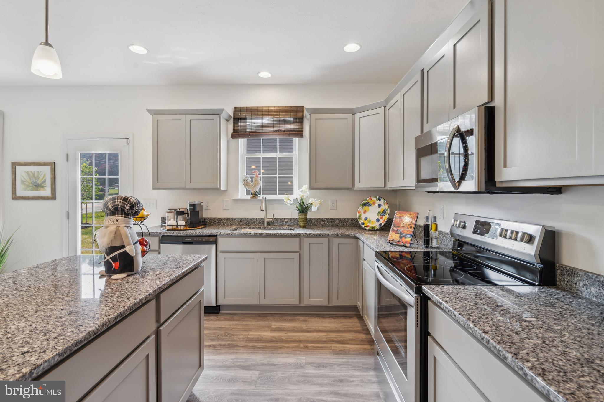 113 Flint Drive Hanover, PA 17331 - Photo 9 of 20 a kitchen with stainless steel appliances granite countertop a sink stove and cabinets