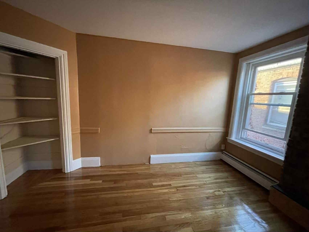 30 Worthington Street, Unit 3 Boston, MA 02120 - Photo 2 of 7 a view of an empty room with wooden floor and a window