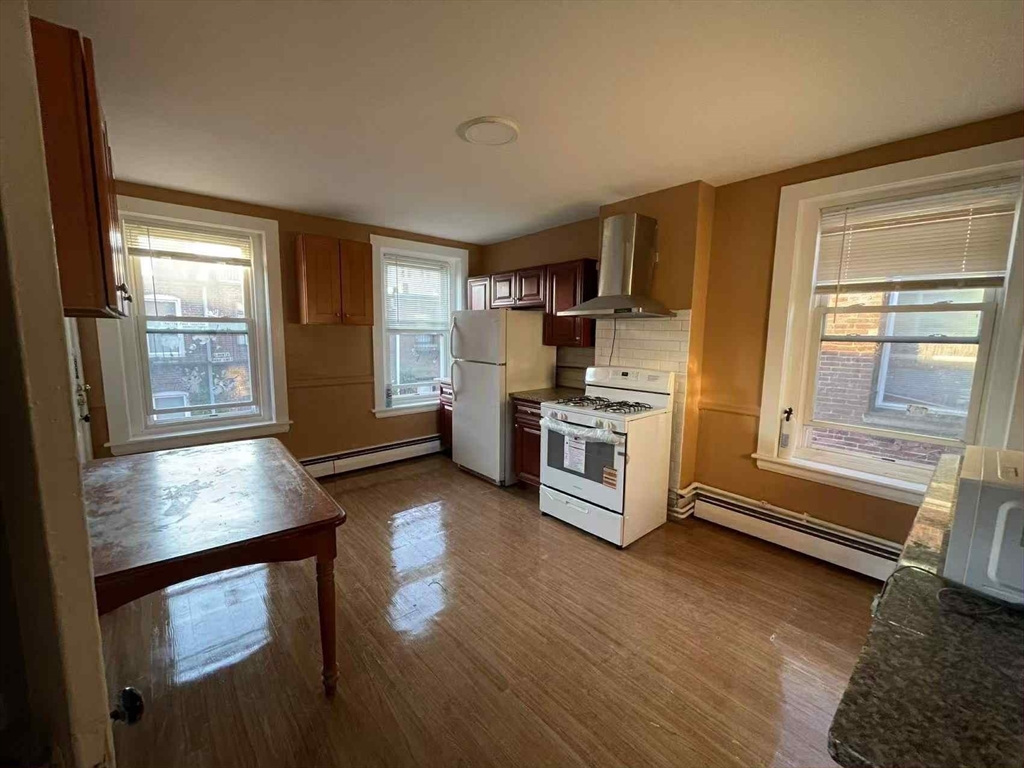 30 Worthington Street, Unit 3 Boston, MA 02120 - Photo 3 of 7 a kitchen with wooden floors and appliances