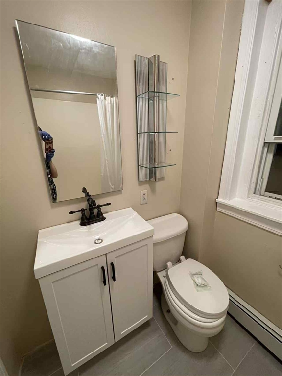 30 Worthington Street, Unit 3 Boston, MA 02120 - Photo 6 of 7 a bathroom with a toilet sink and mirror
