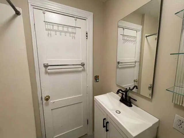 a bathroom with a sink a toilet and a mirror