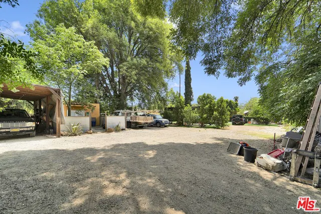 a view of a chair and tables in the patio