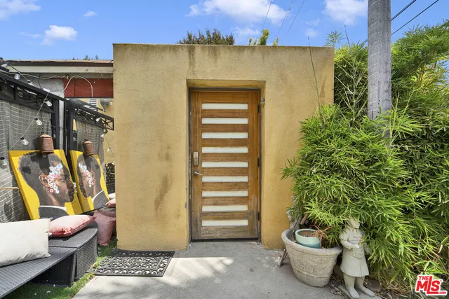a front view of a house with sitting area