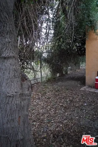 a pathway of a house with wooden fence