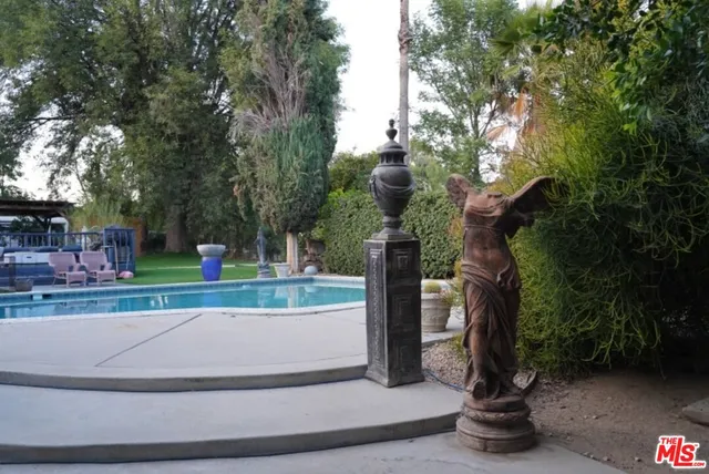 a view of a patio with chairs and a fountain