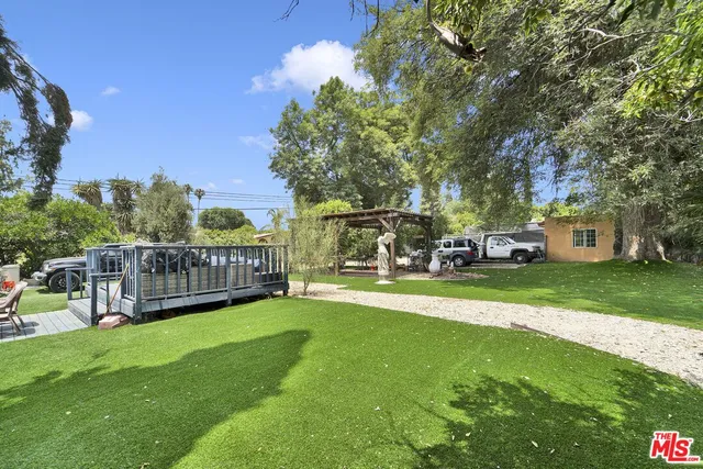 a view of an outdoor space with garden and trees