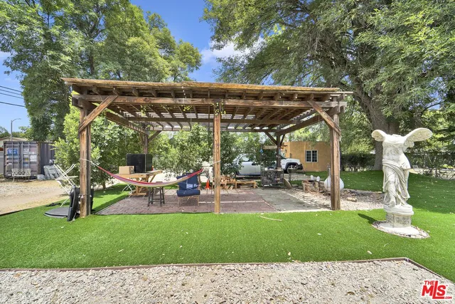 a view of a backyard with a car parked in the road