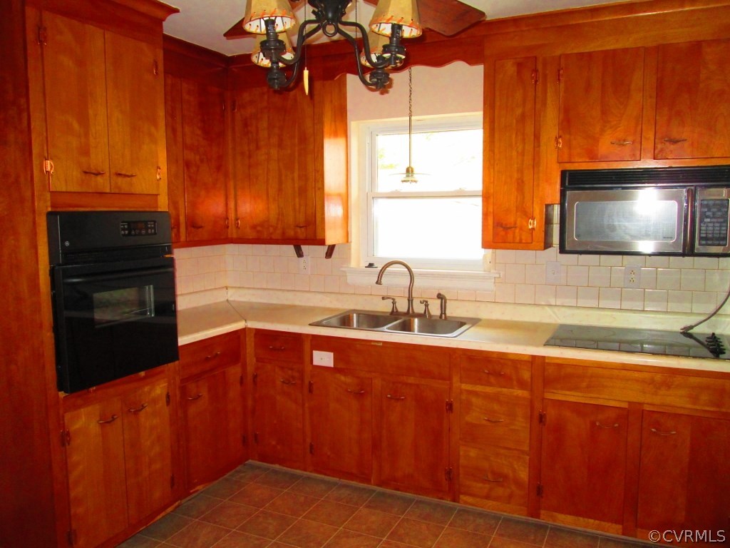 4875 Burnham Road North Chesterfield, VA 23234 - Photo 3 of 18 a kitchen with stainless steel appliances wooden cabinets a sink and a microwave