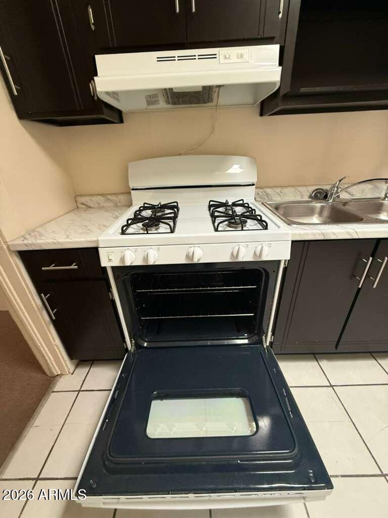 830 East 9th Street, Unit 3 Douglas, AZ 85607 - Photo 11 of 17 a stove top oven sitting inside of a kitchen