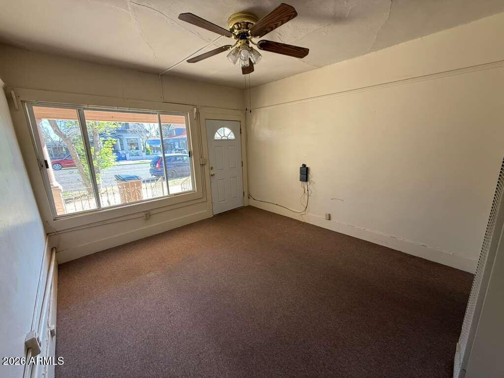 830 East 9th Street, Unit 3 Douglas, AZ 85607 - Photo 4 of 17 en empty room with windows and ceiling fan