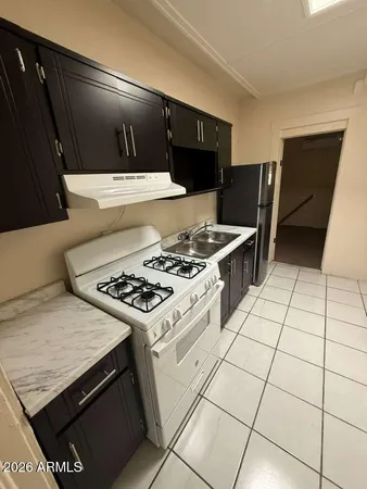 a kitchen with a stove and a refrigerator