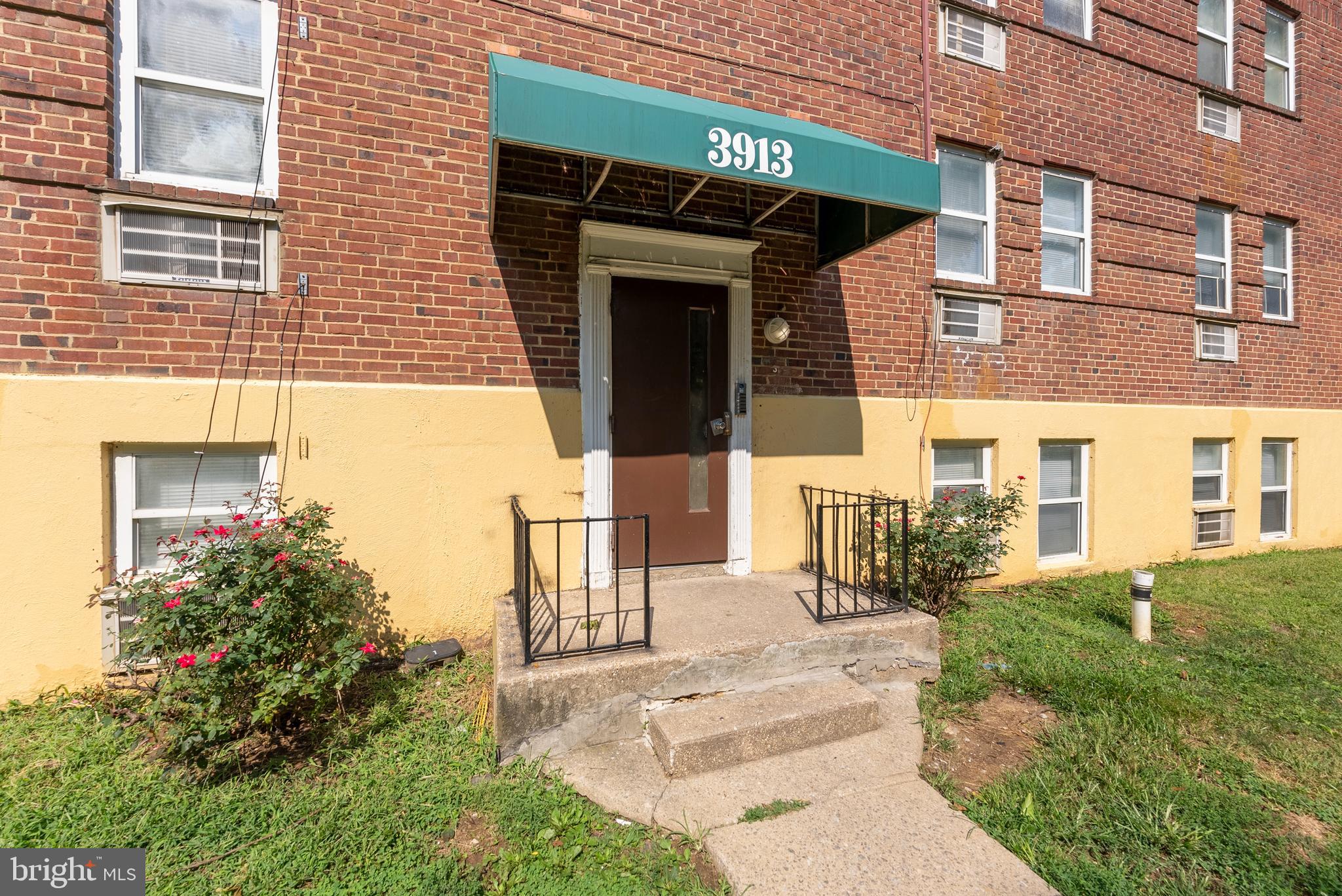 3904 Penhurst Avenue, Unit D Baltimore, MD 21215 - Photo 1 of 11 a view of a house with a small yard and plants