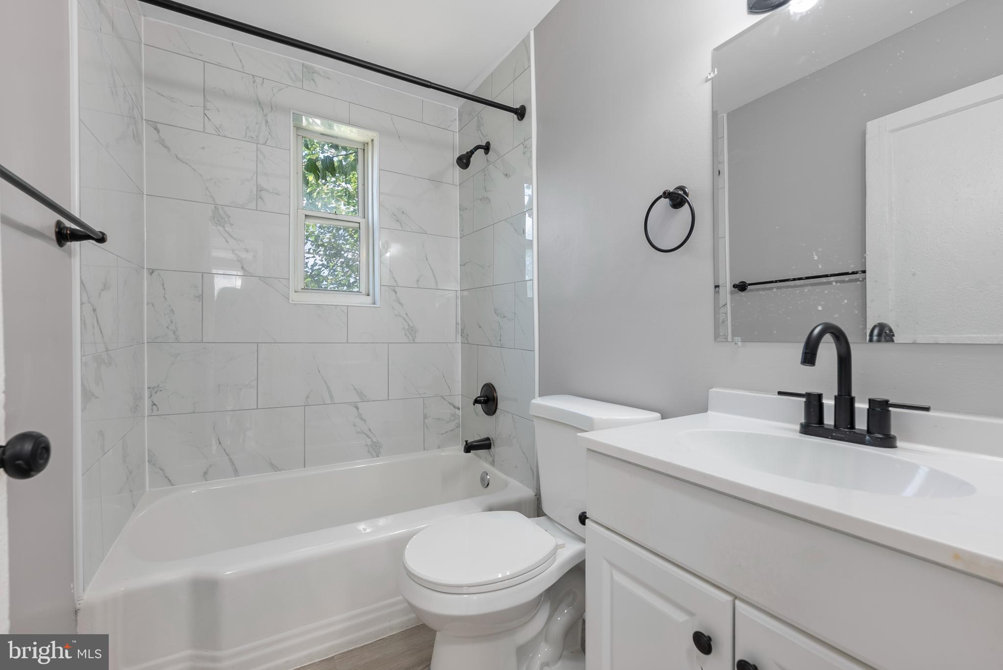 3904 Penhurst Avenue, Unit D Baltimore, MD 21215 - Photo 11 of 11 a bathroom with a sink a toilet and a bathtub