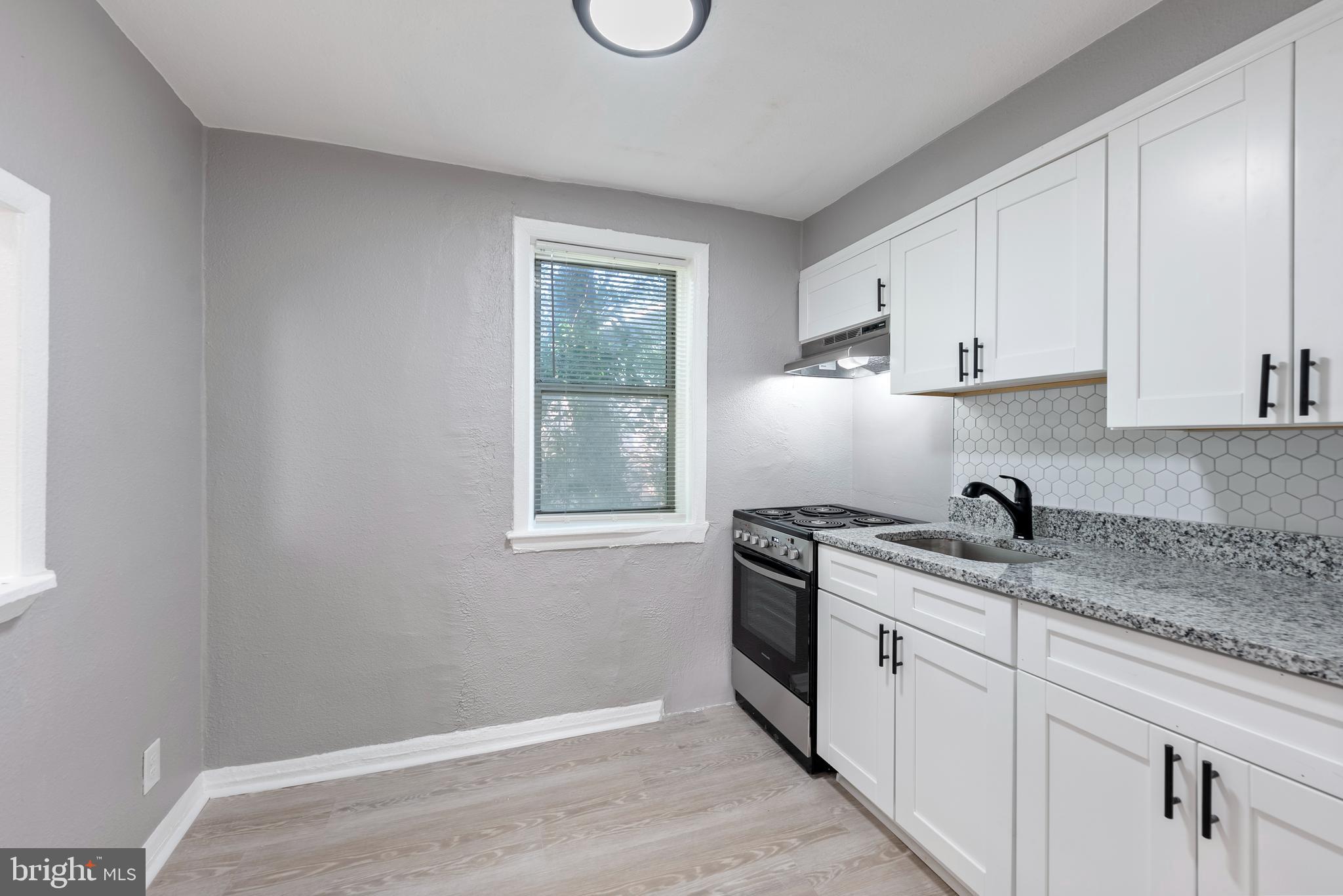 3904 Penhurst Avenue, Unit D Baltimore, MD 21215 - Photo 6 of 11 a kitchen with a sink stove and cabinets