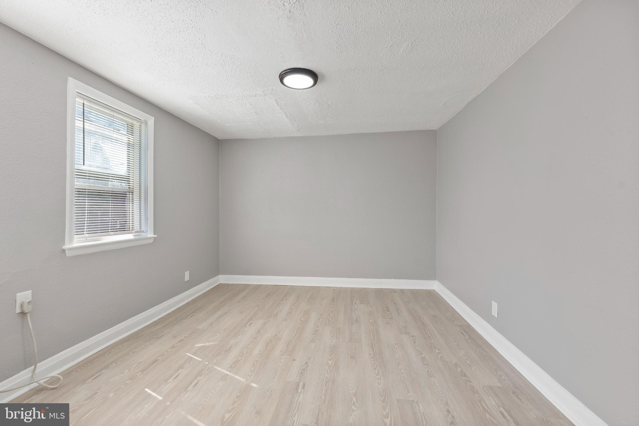 3904 Penhurst Avenue, Unit D Baltimore, MD 21215 - Photo 9 of 11 an empty room with a window