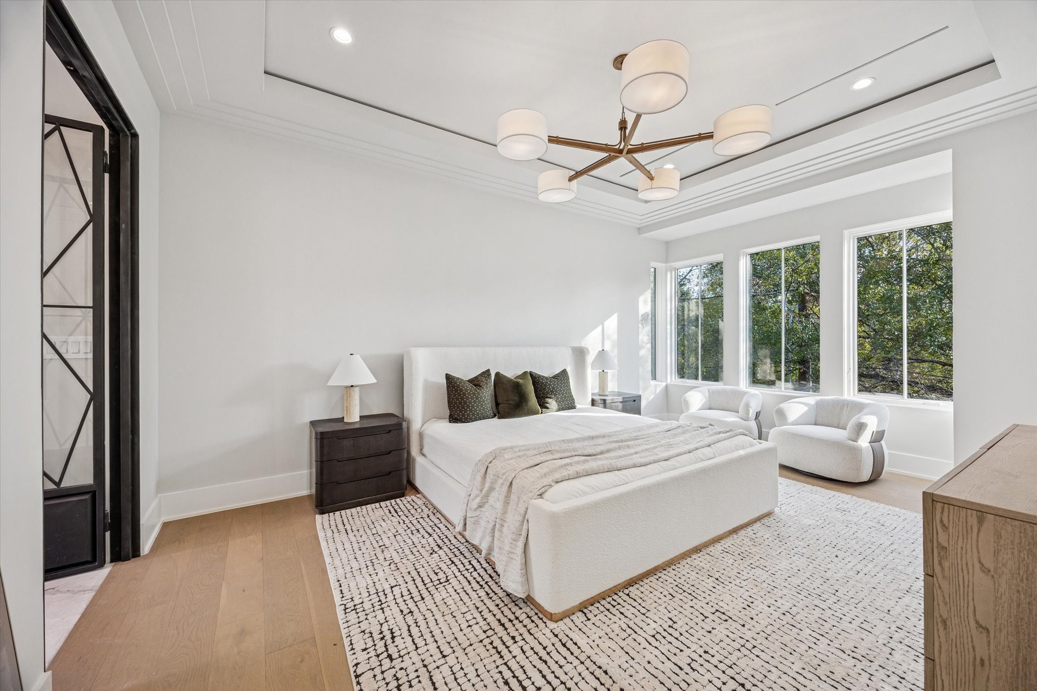 1801 Sunset Boulevard Houston, TX 77005 - Photo 10 of 20 a bedroom with a large bed and a chandelier