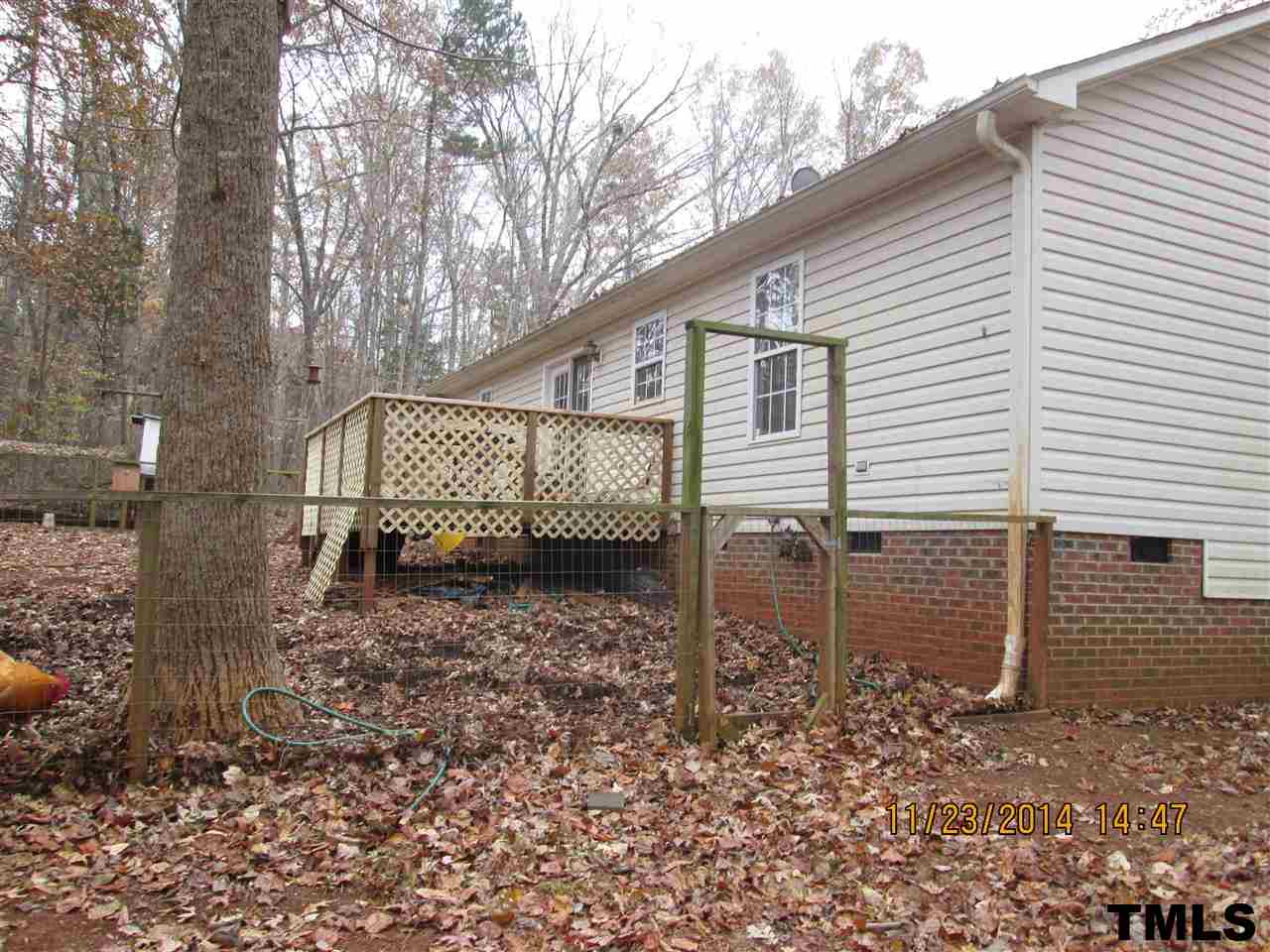286 Little Creek Road Timberlake, NC 27583 - Photo 4 of 11 a view of a house with a yard and wooden fence