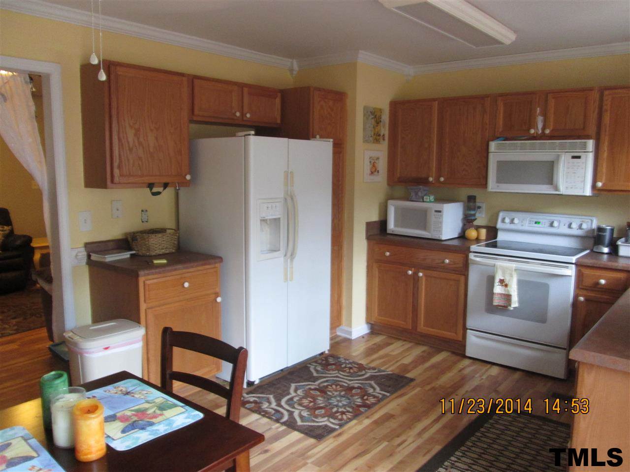 286 Little Creek Road Timberlake, NC 27583 - Photo 8 of 11 a kitchen with a refrigerator and a stove top oven
