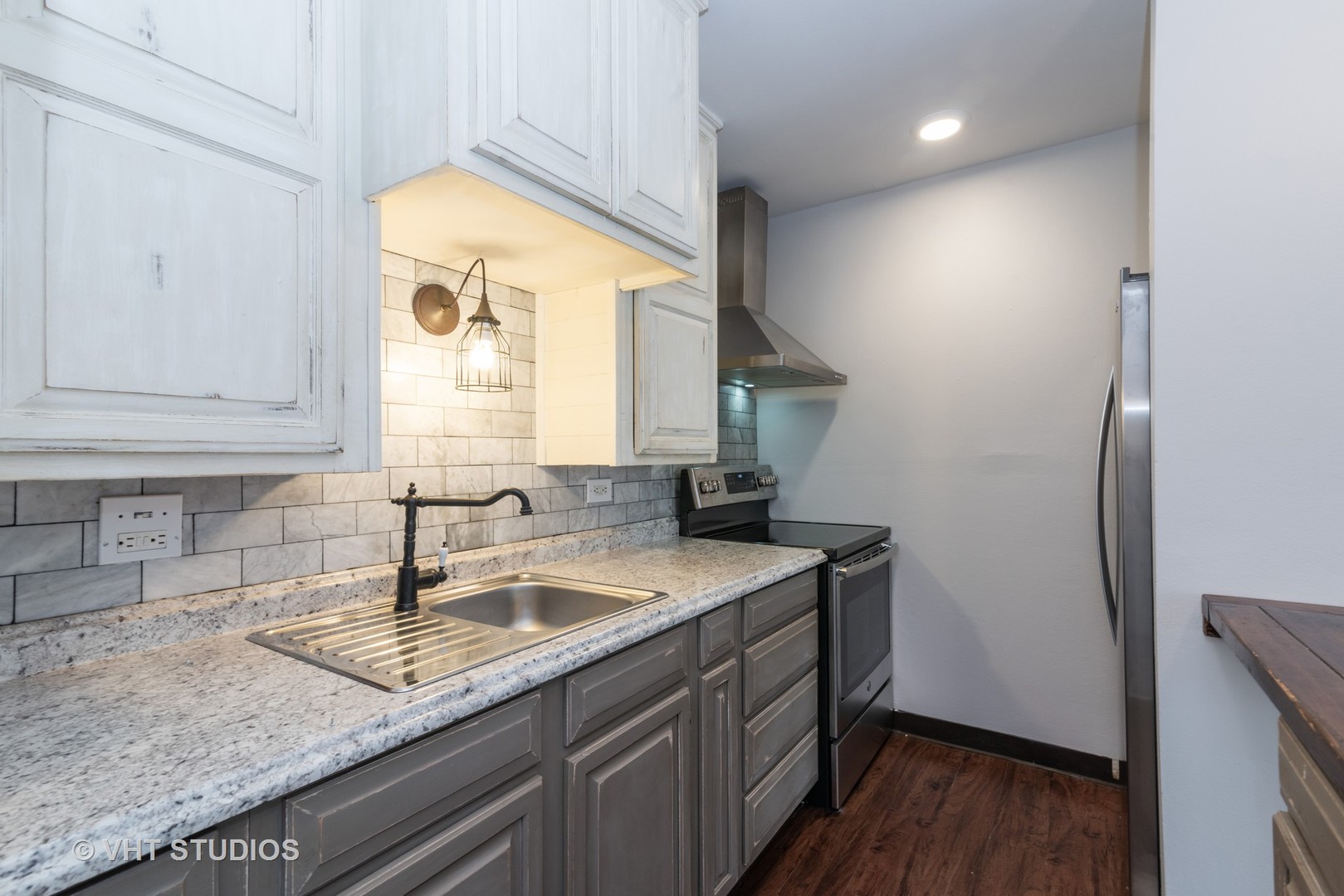 920 Ridge Square, Unit 216 Elk Grove Village, IL 60007 - Photo 2 of 12 a kitchen with a sink a window and cabinets
