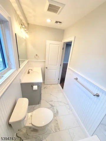 a bathroom with a sink toilet and mirror