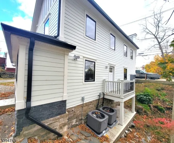 a view of a house with backyard and deck
