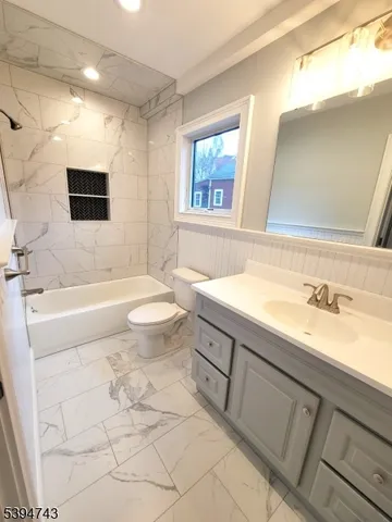 a spacious bathroom with a sink a toilet and a bathtub