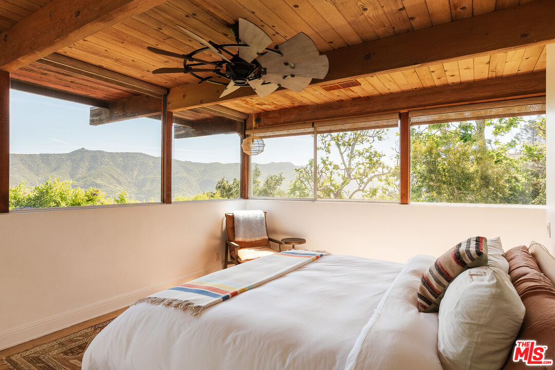 26237 Fairside Road Malibu, CA 90265 - Photo 29 of 34 a bedroom with a bed and a large window