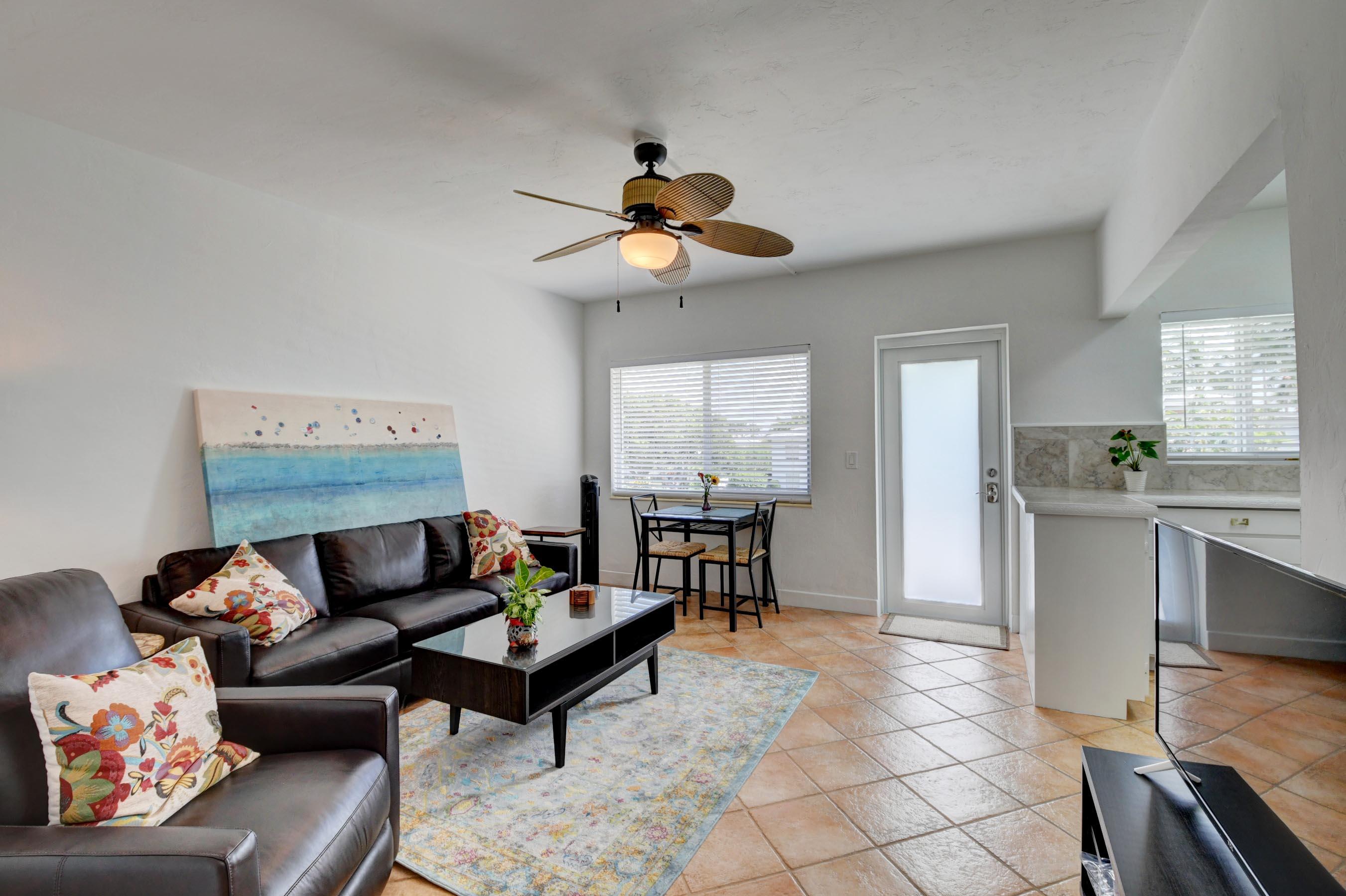 1006 Casuarina Road, Unit 8 Delray Beach, FL 33483 - Photo 1 of 19 a living room with furniture a flat screen tv and a window