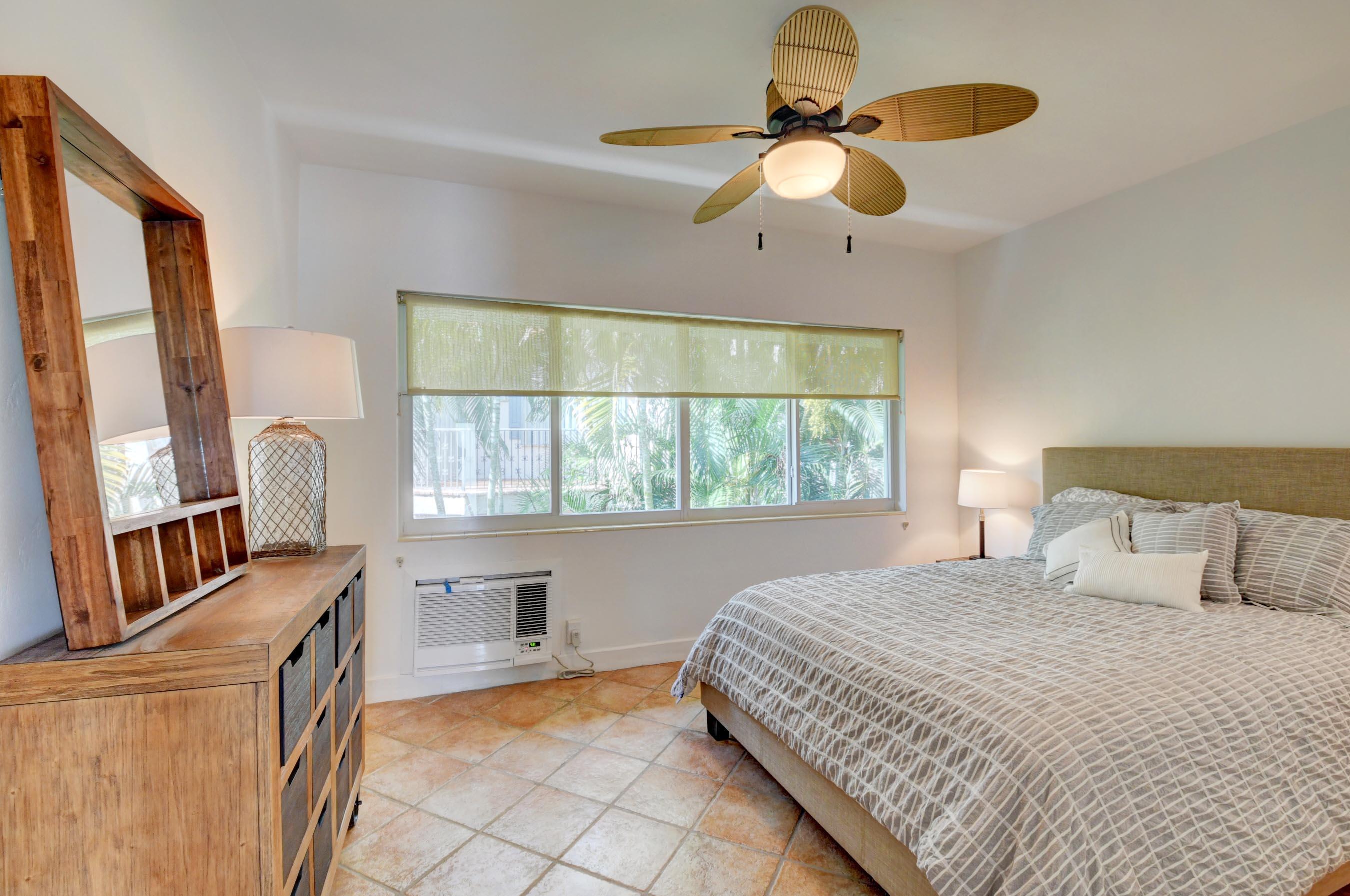 1006 Casuarina Road, Unit 8 Delray Beach, FL 33483 - Photo 12 of 19 a bedroom with a bed dresser and a window