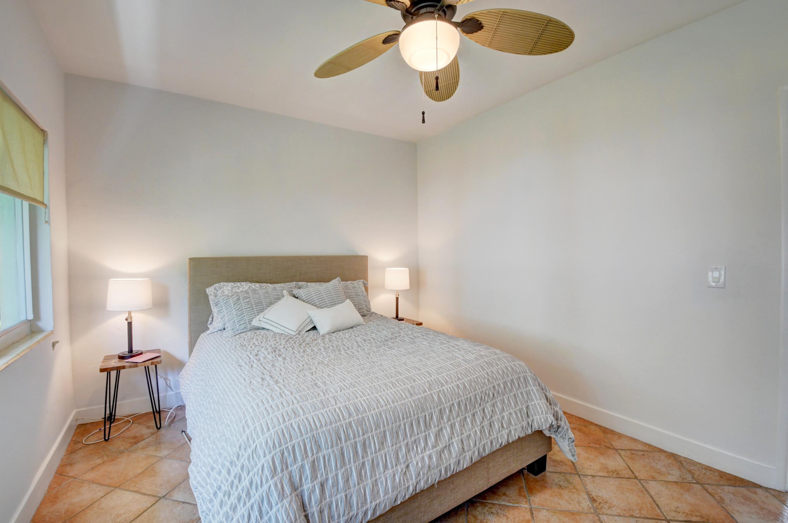 1006 Casuarina Road, Unit 8 Delray Beach, FL 33483 - Photo 14 of 19 a bedroom with a bed and chandelier
