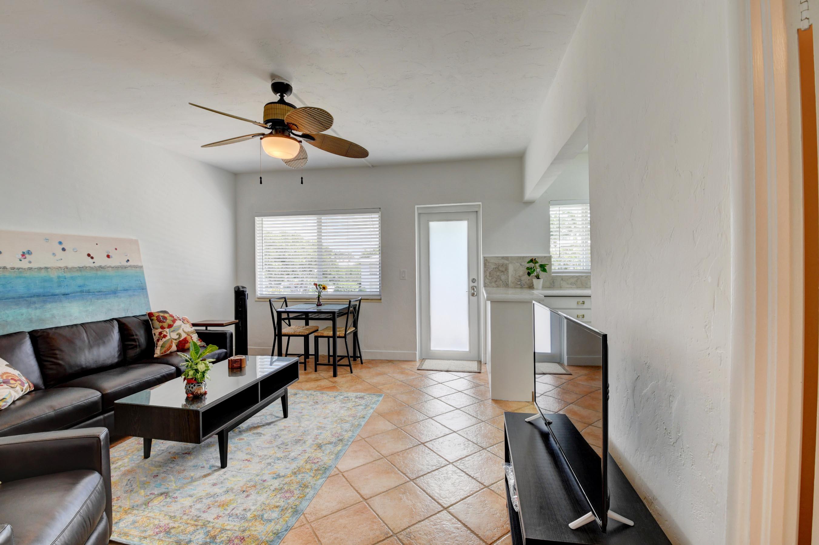 1006 Casuarina Road, Unit 8 Delray Beach, FL 33483 - Photo 15 of 19 a living room with furniture a dining table and a window