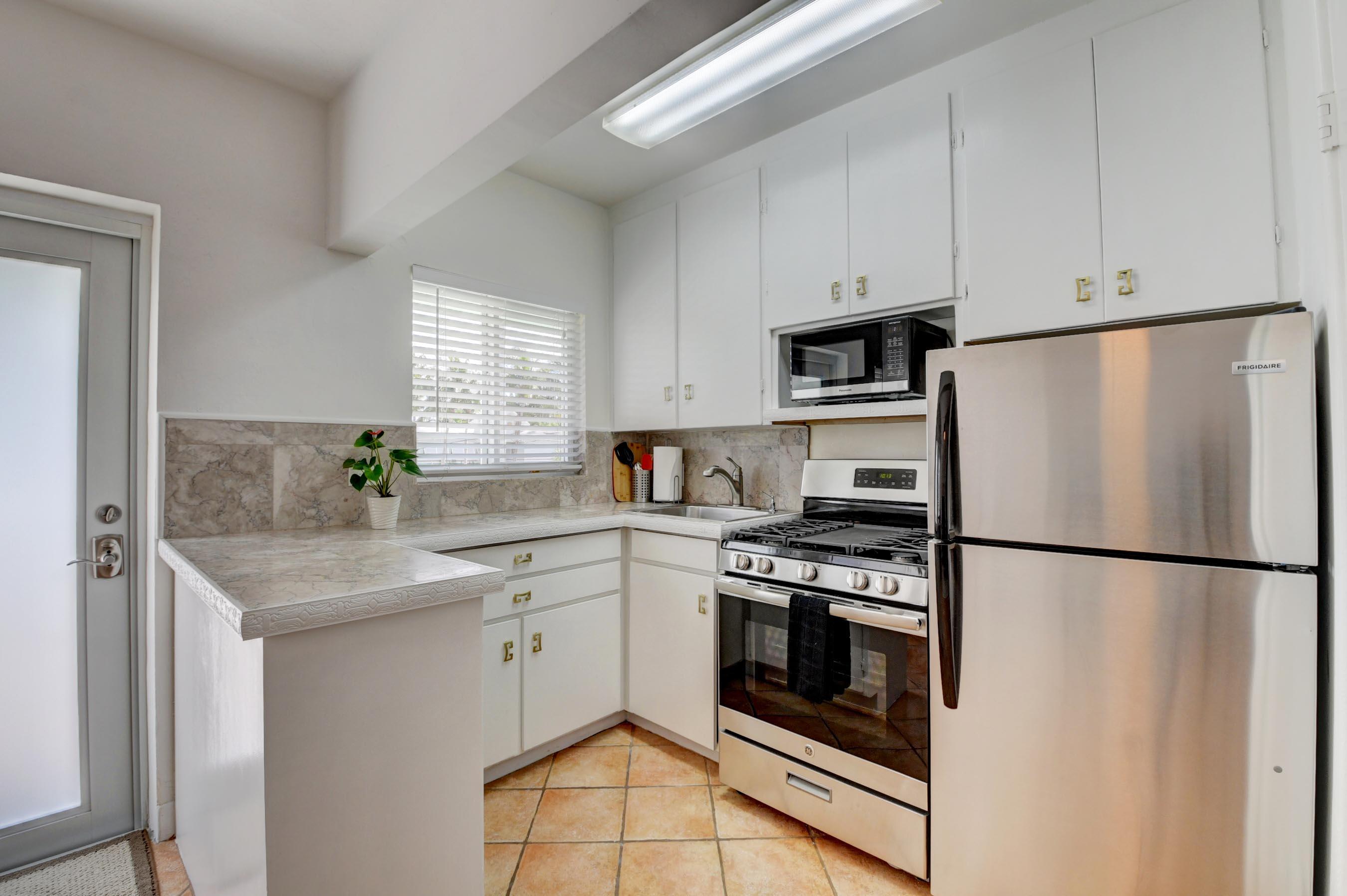 1006 Casuarina Road, Unit 8 Delray Beach, FL 33483 - Photo 6 of 19 a kitchen with cabinets stainless steel appliances and a counter space