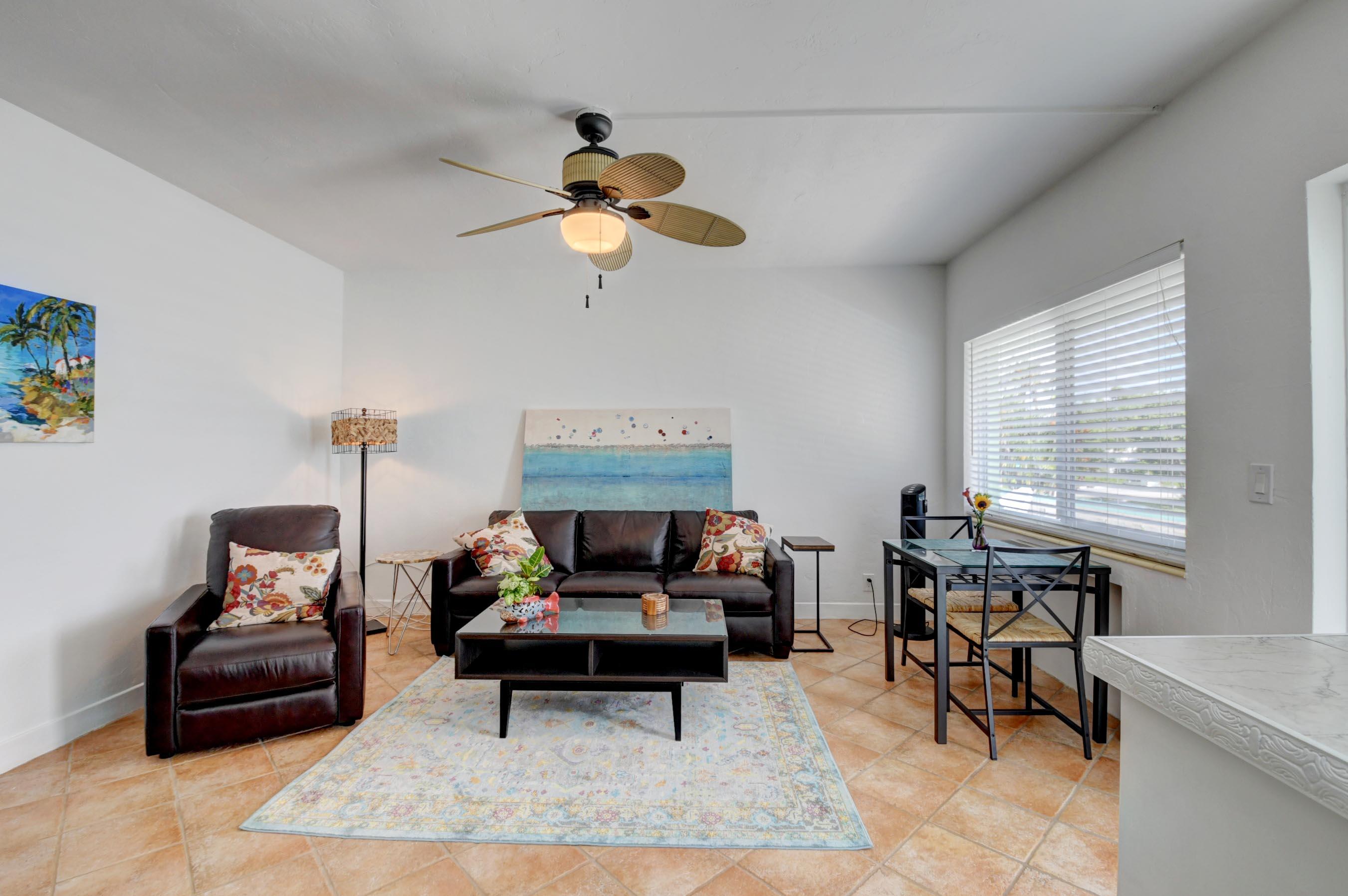 1006 Casuarina Road, Unit 8 Delray Beach, FL 33483 - Photo 8 of 19 a living room with furniture a rug and a window
