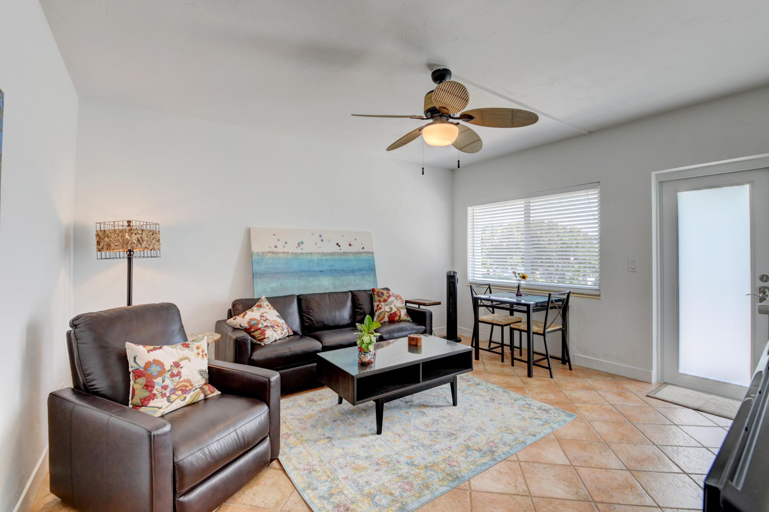 1006 Casuarina Road, Unit 8 Delray Beach, FL 33483 - Photo 10 of 19 a living room with furniture a ceiling fan and a window
