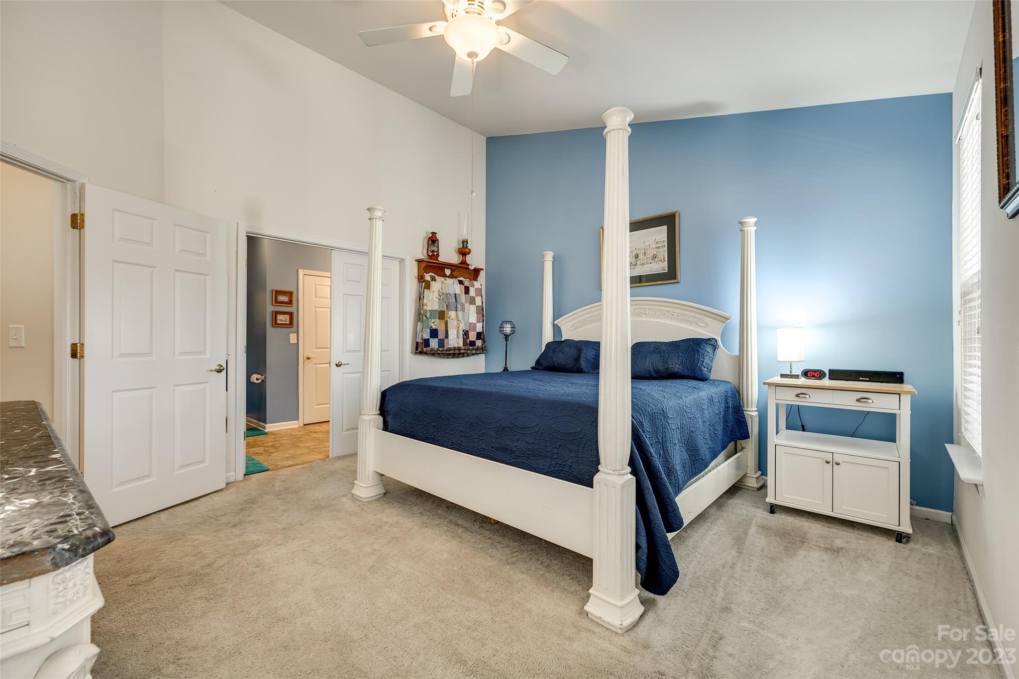 1659 Onyx Ridge Fort Mill, SC 29708 - Photo 13 of 42 a bedroom with a bed and a chandelier