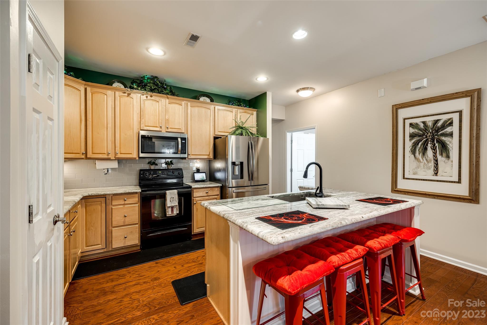 1659 Onyx Ridge Fort Mill, SC 29708 - Photo 17 of 42 a kitchen with a refrigerator a stove a sink dishwasher with a dining table and chairs
