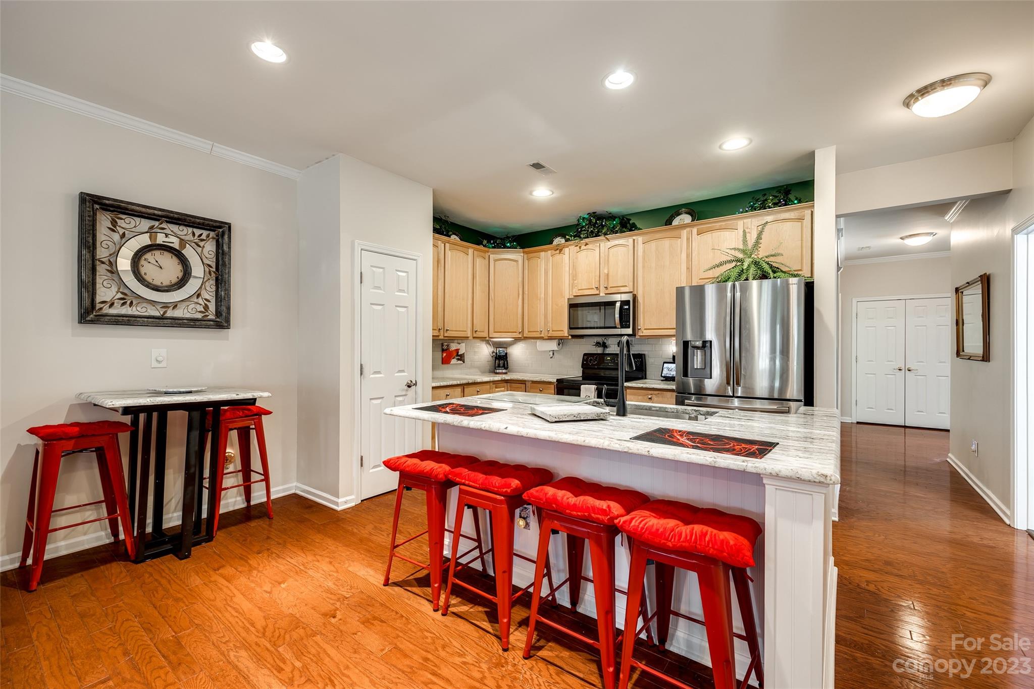 1659 Onyx Ridge Fort Mill, SC 29708 - Photo 19 of 42 a kitchen with stainless steel appliances granite countertop a refrigerator a stove top oven a sink dishwasher and white cabinets with wooden floor