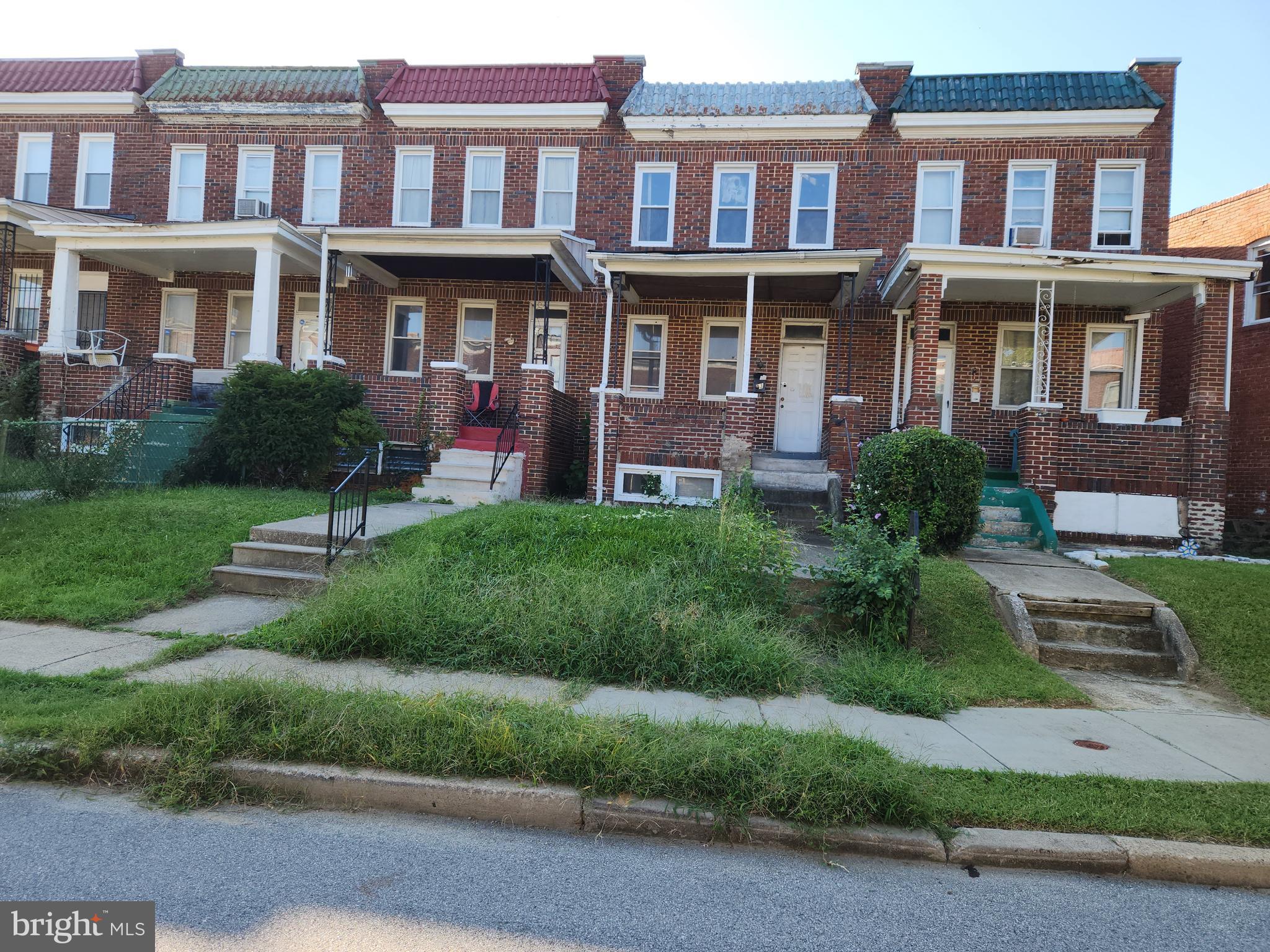 a view of a brick building next to a yard