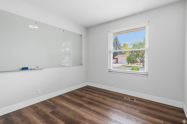 2693 Teal Way Sandy, UT 84093 - Photo 20 of 50 Bright room featuring wood-finish flooring, white baseboards, a large window with blinds, and a wall-mounted glass whiteboard