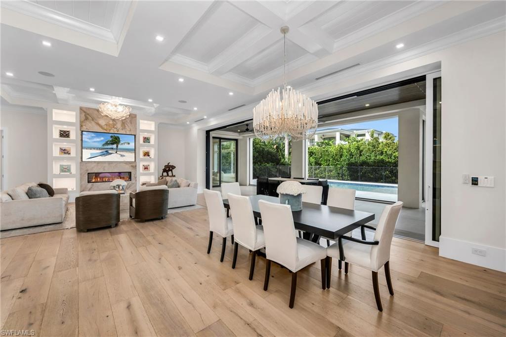 3190 Crayton Road Naples, FL 34103 - Photo 11 of 48 a large kitchen with a table and chairs