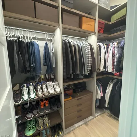 a bedroom with a bed and a night stand